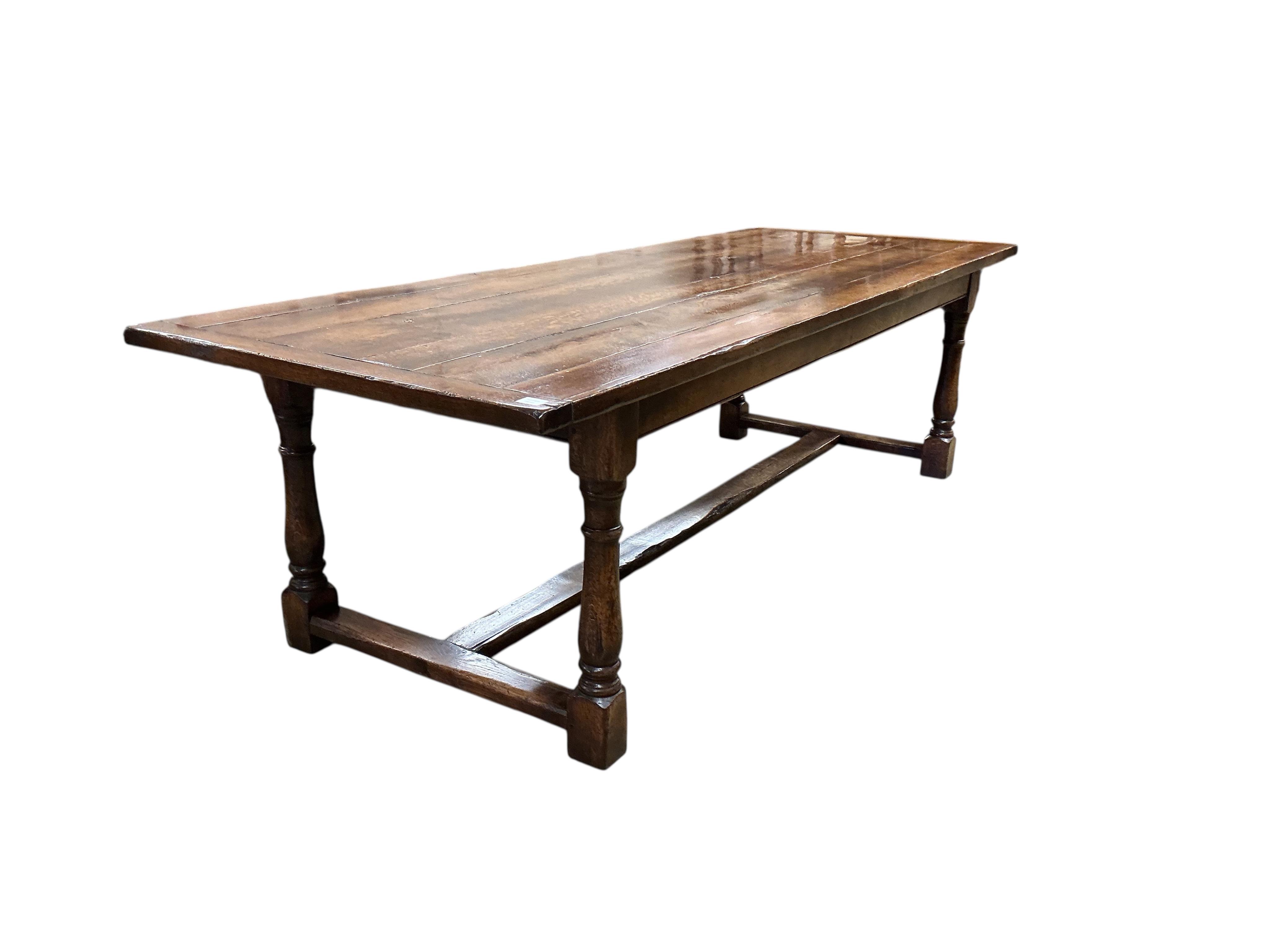A 17th century style rectangular oak refectory dining table, with cleated six plank top, width 274cm, depth 102cm, height 79cm